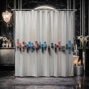 May include: A shower curtain featuring a vertical striped pattern in shades of gray, white, and black, accented by thin orange lines. A horizontal row of three-dimensional, gear-like shapes in blue, orange, and gray is attached across the center.