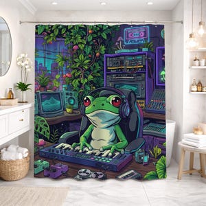 May include: A vibrant shower curtain featuring a cartoon frog wearing headphones and playing a keyboard in a music studio setting. The design includes a cityscape, plants, and audio equipment in shades of green, purple, and blue.