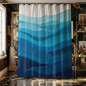 May include: A blue and white shower curtain with a layered wave design. The curtain features shades of blue, from light to dark, creating a textured, ocean-like appearance. The top portion is white, transitioning into the blue waves.