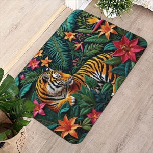 May include: A rectangular doormat featuring a tiger amidst lush tropical foliage. The tiger has orange and black stripes, surrounded by green leaves and vibrant orange, pink, and red flowers. The mat is designed to welcome guests.