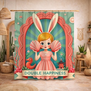 May include: A decorative shower curtain with a cartoon illustration of a girl in bunny ears holding pink seashell fans. The design features a pink and teal colour scheme, with the text "DOUBLE HAPPINESS" on a banner.