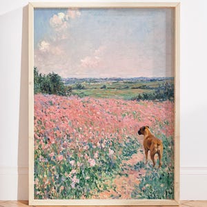 May include: Framed art print of a field of pink flowers with a brown dog. The artwork has a light blue sky with clouds and a green landscape in the background. The frame is a light wood color.