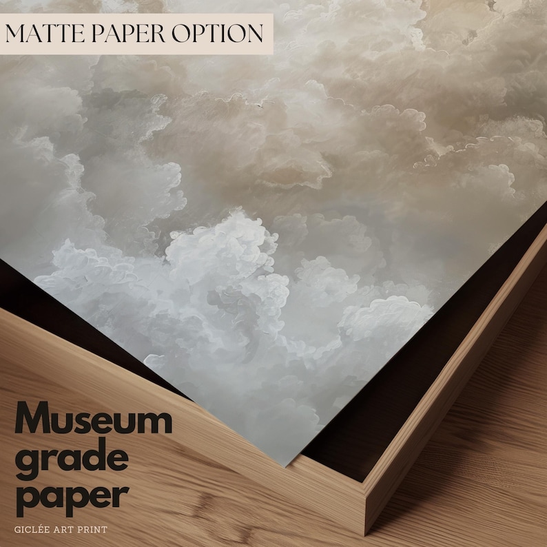 Peut inclure: Gros plan sur une impression de nuages blancs et beiges sur du papier de qualit&eacute; mus&eacute;e. Le papier est pli&eacute; sur un cadre en bois. Le texte "Matte Paper Option" est visible en haut &agrave; gauche. Le texte "Museum grade paper" et "Gicl&eacute;e Art Print" est visible en bas &agrave; gauche.