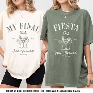 May include: Two oversized t-shirts with a bachelorette party theme. The ivory shirt says "My Final Fiesta" with a margarita graphic and "Sarah's Bachelorette Tulum". The moss green shirt says "Fiesta Club" with a margarita graphic and "Sarah's Bachelorette Tulum".
