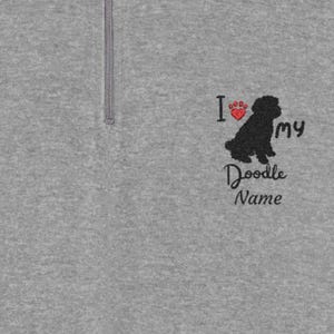 May include: Gray quarter-zip sweatshirt with embroidered text and graphic. The design includes a black silhouette of a dog, a red heart with a paw print, and the words "I ❤️ my Doodle Name."