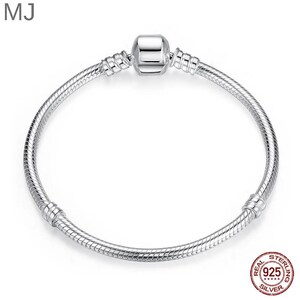 May include: A silver bracelet with a snake chain design. The bracelet has a square clasp in the centre and is marked with a "925 Silver" stamp. A classic piece of jewellery.