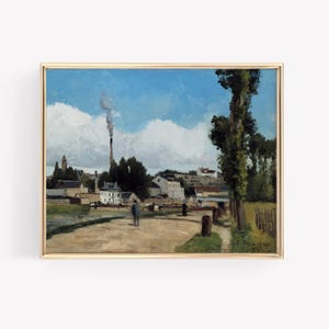May include: A framed landscape painting with a gold border. The artwork depicts a rural scene with buildings, trees, and a road under a blue sky with clouds. A tall smokestack emits smoke.