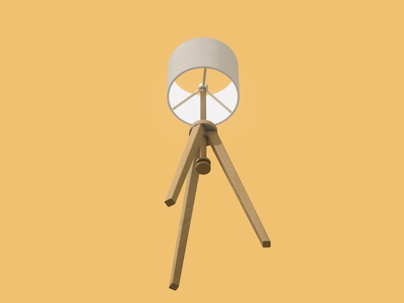 May include: A white lampshade with a wooden tripod base. The lampshade is cylindrical and has a white fabric covering. The tripod base is made of three wooden legs that meet at a point in the center of the lampshade.