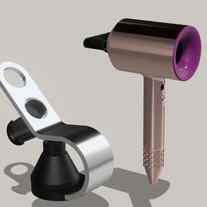 May include: A silver hair dryer holder with a black base and a rose gold hair dryer with a purple nozzle.