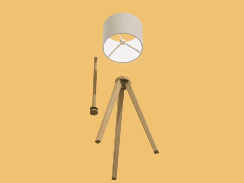 May include: A wooden tripod floor lamp with a white fabric lampshade. The lamp is disassembled, showing the separate parts.