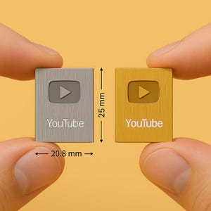 May include: Two small, square, metal YouTube buttons. The button on the left is silver with a white YouTube logo and the button on the right is gold with a white YouTube logo. The buttons are 25 mm tall and 20.8 mm wide.
