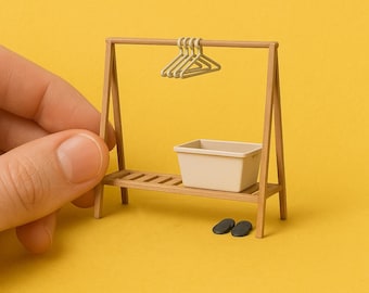 May include: A miniature wooden clothing rack with a shelf, a small white plastic bin, and two black flip-flops. The rack has a wooden bar with five silver hangers.