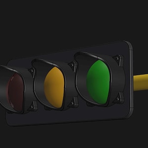 May include: A traffic light with three lights: red, yellow, and green. The green light is on.