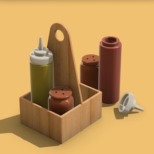 May include: A wooden condiment caddy with a handle holds a green squeeze bottle, a brown salt shaker, and a red squeeze bottle. A white funnel and a brown salt shaker are also present. The items are on a yellow background.