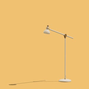 May include: A white floor lamp with a white shade and a gold accent. The lamp is on a yellow background.