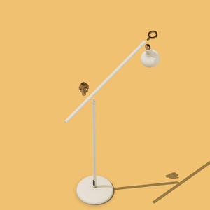 May include: A white desk lamp with a long, adjustable arm and a white, round base. The lamp has a white shade with a gold accent.