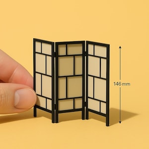 May include: A black three-panel room divider with a geometric design. Each panel has a grid of rectangular openings with a cream-colored background. The divider is 146 mm tall.