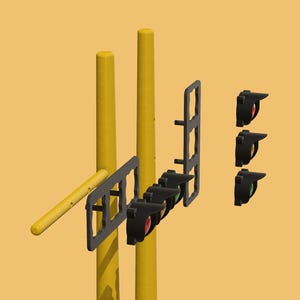 May include: A set of traffic lights with three black housings and red, yellow, and green lights. The lights are mounted on two yellow poles.