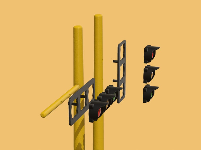 May include: A set of traffic lights with three black housings and red, yellow, and green lights. The lights are mounted on two yellow poles.