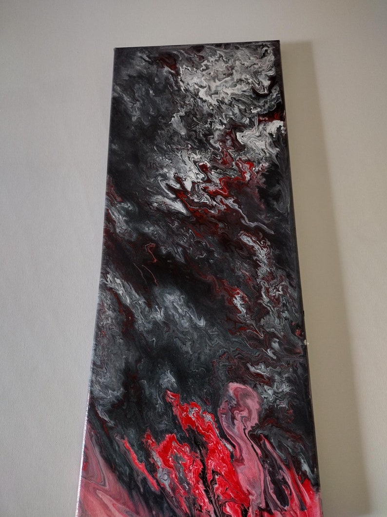 May include: Abstract painting on canvas with swirling red, black, and white paint. The colors create a dynamic and energetic composition.