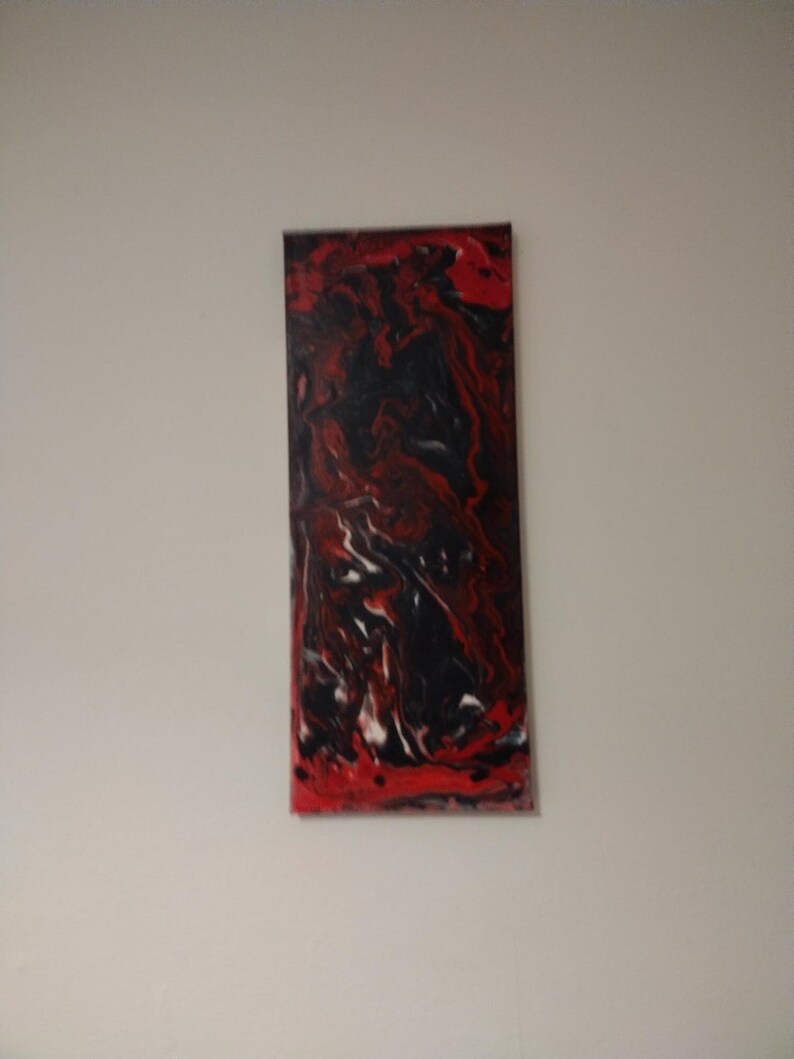 May include: Abstract painting on canvas with swirling red, black, and white paint.