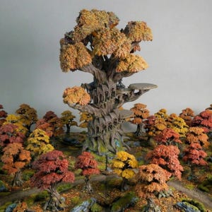 Peut inclure: Une miniature détaillée d'un arbre fantastique avec plusieurs plateformes et un escalier en colimaçon, entouré d'une forêt d'arbres aux couleurs automnales. Les feuilles sont dans les tons de rouge, d'orange et de jaune. Le tronc de l'arbre central est grand et texturé.