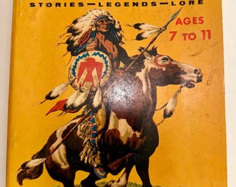 May include: A vintage softcover book titled The Cub Scout Book of Cowboys and Indians Stories-Legends-Lore. The yellow cover features an illustration of a person in a feathered headdress riding a brown and white horse, holding a spear and shield.