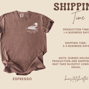 May include: Espresso-colored t-shirt featuring a graphic of a loon with the text "STUPID CANADIAN WOLF BIRD." The shirt has a crew neck and short sleeves. The shirt is made of a soft material.