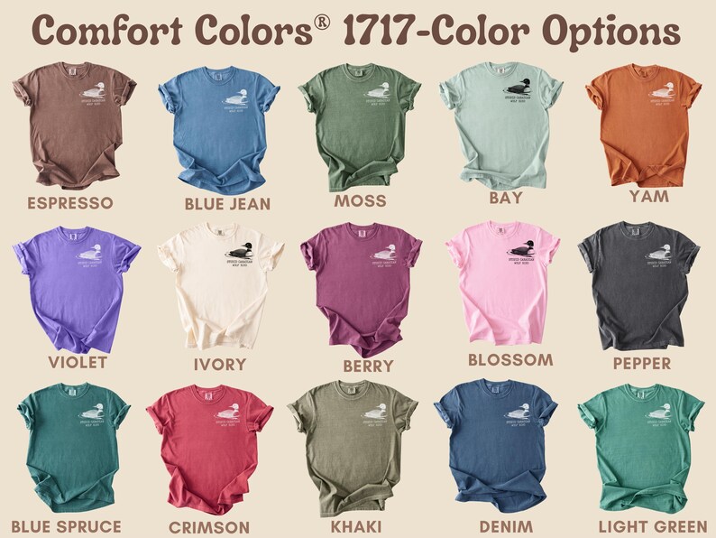 May include: A collection of Comfort Colors 1717 t-shirts in various colors, including Espresso, Blue Jean, Moss, and Yam. Each shirt features a small graphic on the chest and is displayed with its color name.