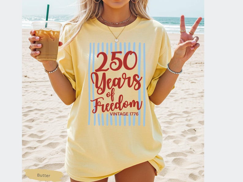 Woman wearing butter Comfort Colors patriotic shirt featuring “250 Years of Freedom Vintage 1776” retro red and blue design for Fourth of July celebration