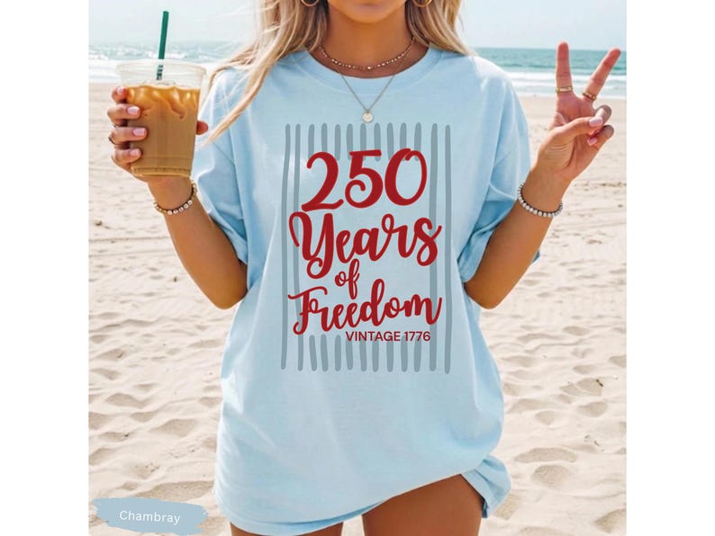 Woman wearing chambray Comfort Colors patriotic shirt featuring “250 Years of Freedom Vintage 1776” retro red and blue design for Fourth of July celebration