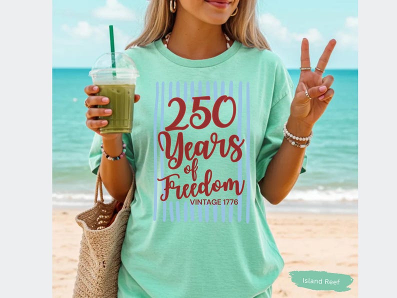 Woman wearing island reef Comfort Colors patriotic shirt featuring “250 Years of Freedom Vintage 1776” retro red and blue design for Fourth of July celebration