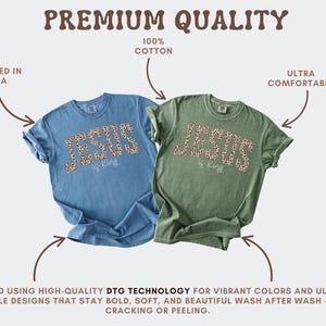 Op de afbeelding: Twee T-shirts, &eacute;&eacute;n blauw en &eacute;&eacute;n groen, met de tekst "JESUS is king" in een luipaardprint. De shirts zijn gemaakt van 100% katoen en worden omschreven als ultra-comfortabel. De afbeelding vermeldt ook dat de shirts in de VS zijn bedrukt.