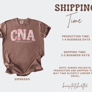 May include: Espresso-coloured t-shirt with the letters "CNA" in a floral and patterned design. The text "certified nursing assistant" is below the letters. The shirt has rolled-up sleeves.
