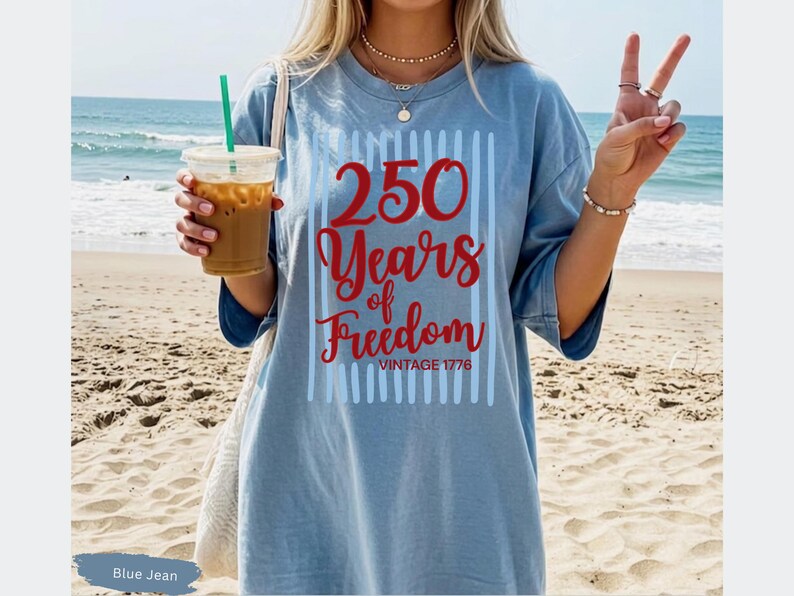 Woman wearing blue jean Comfort Colors patriotic shirt featuring “250 Years of Freedom Vintage 1776” retro red and blue design for Fourth of July celebration