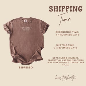 May include: Espresso-colored t-shirt with rolled sleeves. The shirt features the text "THE SUMMER I TURNED THIRTY" in a small, centered font. The shirt is a vintage style and is likely made of soft cotton.