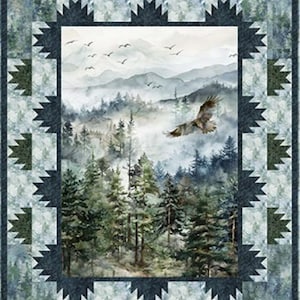 May include: A rectangular quilt featuring a central panel of a misty forest landscape with a flying eagle and birds. The border consists of a geometric star pattern in dark green and light blue, surrounded by a forest-themed fabric frame.