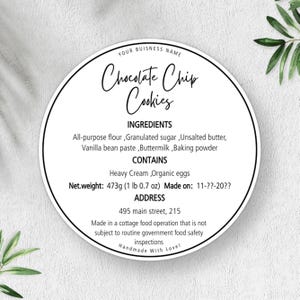 May include: A circular white label with black text featuring the heading Chocolate Chip Cookies, an ingredients list including all-purpose flour and unsalted butter, allergen information, a net weight of 473g, and address details for a cottage food operation.
