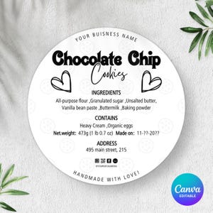 May include: A round white label with the text "Chocolate Chip Cookies" in a black, stylized font. The label includes ingredient and net weight information, along with the text "Handmade with Love!" and a business name at the top.