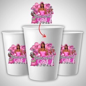 May include: White paper cups with a pink graphic. The graphic features a woman in a pink dress, surrounded by pink balloons, money, and the text "BIRTHDAY Girl". The cups are ideal for a birthday party.