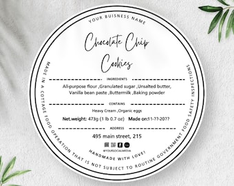 May include: A round white product label with black text and borders. It features the title Chocolate Chip Cookies, an ingredient list including flour, sugar, butter, vanilla, buttermilk, and baking powder, plus net weight 473g (1 lb 0.7 oz).