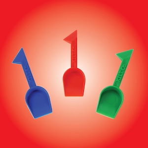 May include: Three brightly coloured plastic scoops in blue, red, and green are shown against a red gradient background. Each scoop has a shovel-like design with a flat, angled handle and a curved scoop. The text "KILT CO." is printed on each handle.