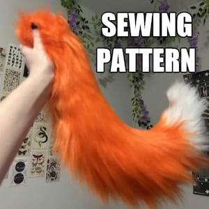 May include: An orange faux fur fox tail with a white tip is held up. The text "SEWING PATTERN" is displayed in a white font with a black outline. The tail is fluffy and vibrant.