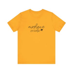 Women’s 'Airplane Mode' graphic tee featuring cursive text and a small airplane. Ideal vacation shirt or adventurer gift. Lightweight and perfect for travel lovers.
