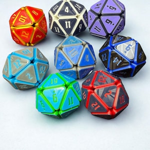 May include: A collection of eight multi-faceted polyhedral dice in various colors including red, purple, blue, green, and grey. Each die features triangular faces with engraved numbers, showcasing a distinct geometric design with contrasting edges.