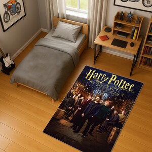 May include: A bedroom scene featuring a twin bed with gray bedding, a wooden desk, and a rug. The rug displays the "Harry Potter" movie poster with the text "Return to Hogwarts". A motorcycle art print hangs on the wall.