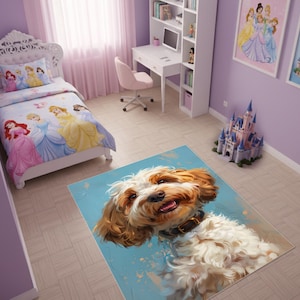 May include: A colorful rug featuring a smiling dog with brown and white fur. The rug has a light blue background with paint-like splatters. The dog is wearing a black collar. The rug is in a child's bedroom with princess-themed bedding.