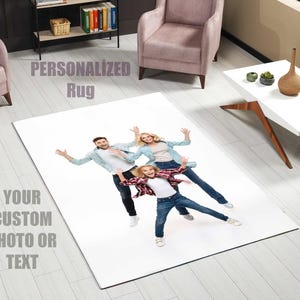 May include: A white rectangular rug with a family photo printed on it. The photo shows a family of three in casual clothing, arms outstretched. The rug has the text "PERSONALIZED Rug" and "YOUR CUSTOM PHOTO OR TEXT" printed on it.