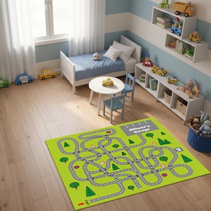 May include: A child's bedroom scene with a green road map rug featuring a maze design. The room includes a white bed, small table and chairs, and toy cars. The rug has the text "Oliver's Garage".