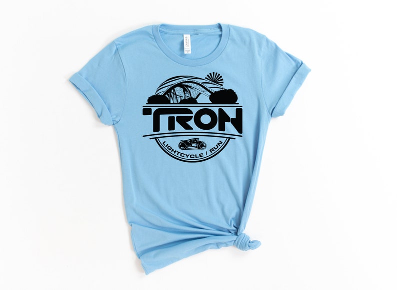 May include: Light blue t-shirt with a black graphic of a Tron lightcycle and the text "TRON LIGHTCYCLE / RUN".